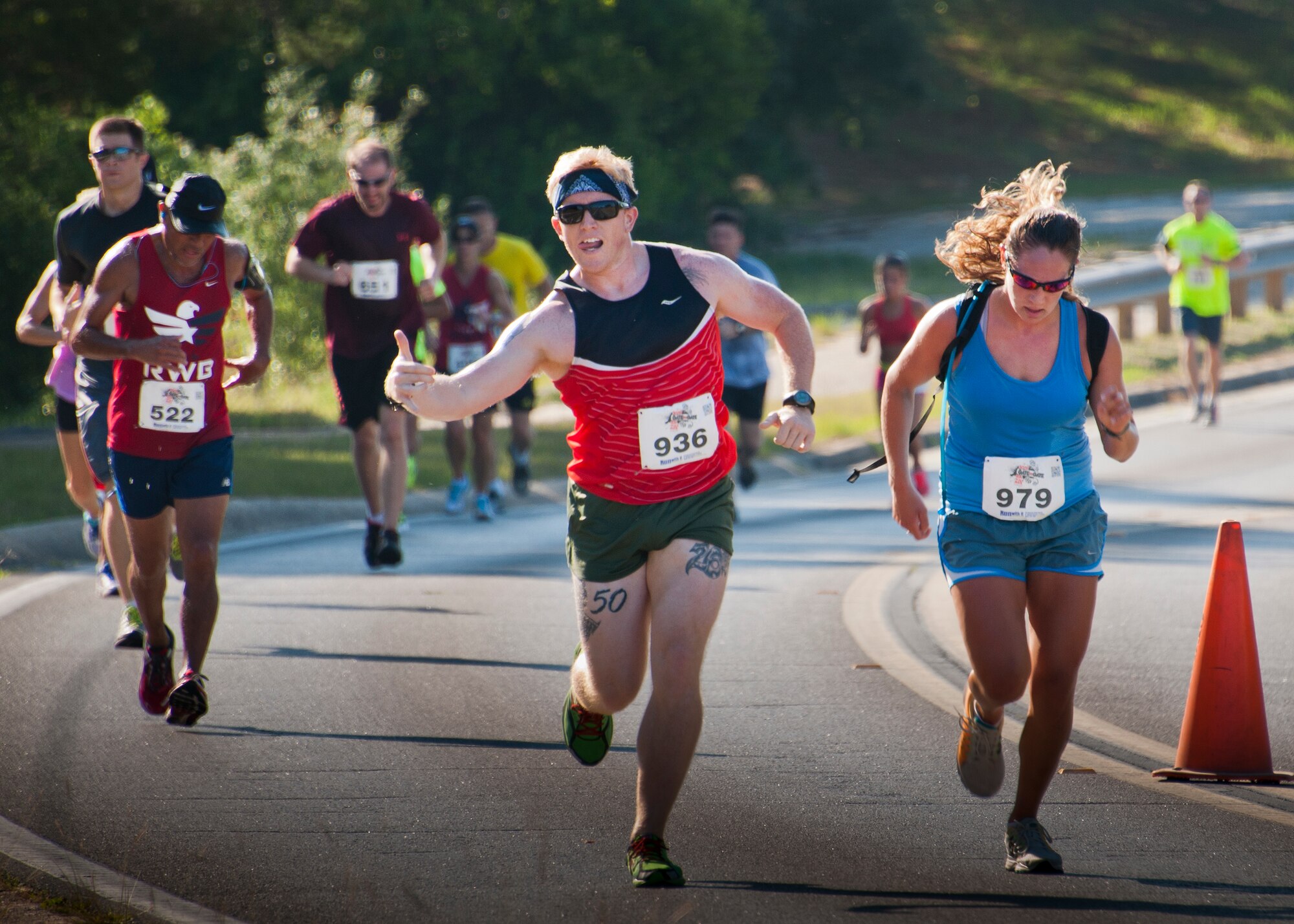 Christopher Bennett gives a thumbs up as he climbs the final hill toward the finish line during the 30th Anniversary Memorial Gate to Gate run May 23 at Eglin Air Force Base, Fla.  More than 1,500 participated in this year’s event.  (U.S. Air Force photo/Samuel King Jr.)