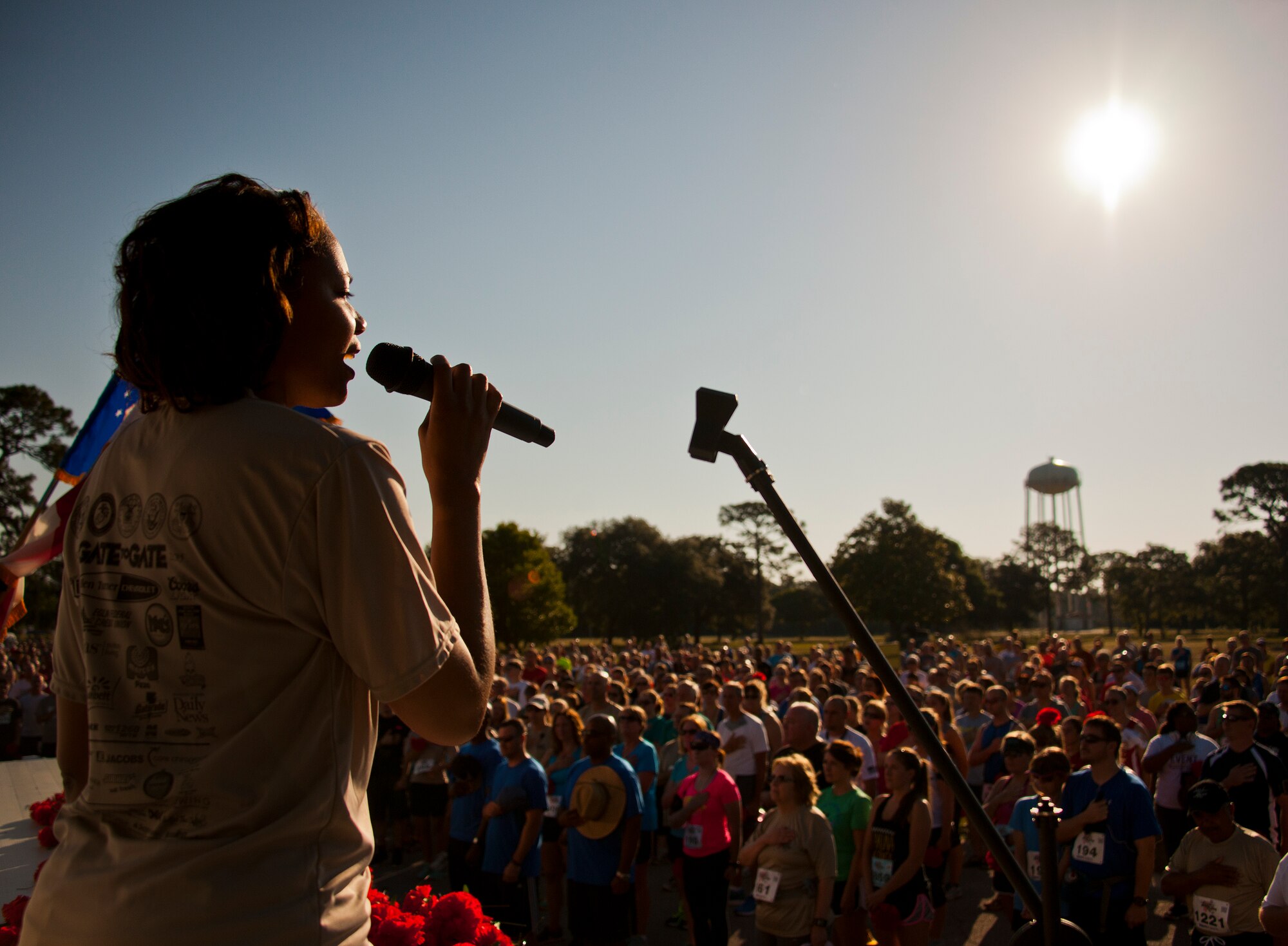 Demetria Stewart sings the National Anthem prior to the 30th Anniversary Memorial Gate to Gate run May 23 at Eglin Air Force Base, Fla.  More than 1,500 participated in this year’s event.  (U.S. Air Force photo/Samuel King Jr.)
