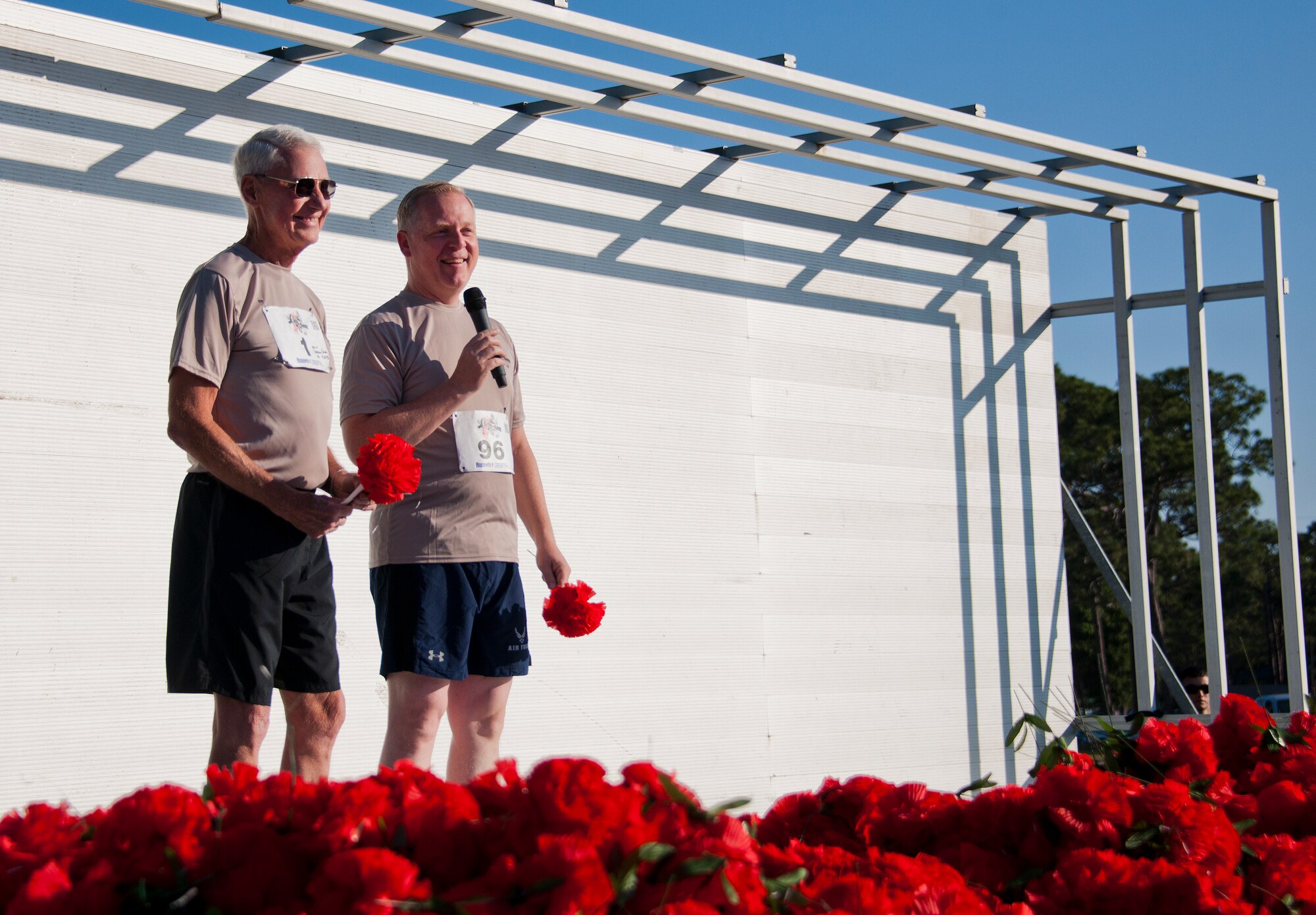 Former base commander, retired Lt. Gen. Gordon Fornell, stands with Brig. Gen. David Harris, 96th Test Wing and current base commander, prior to the 30th Anniversary Memorial Gate to Gate run May 23 at Eglin Air Force Base, Fla.  Fornell, who wore bib number 1, told of how he started the run in 1985 with around 50 people participating that first year.  More than 1,500 ran and walked at this year’s event. (U.S. Air Force photo/Samuel King Jr.)