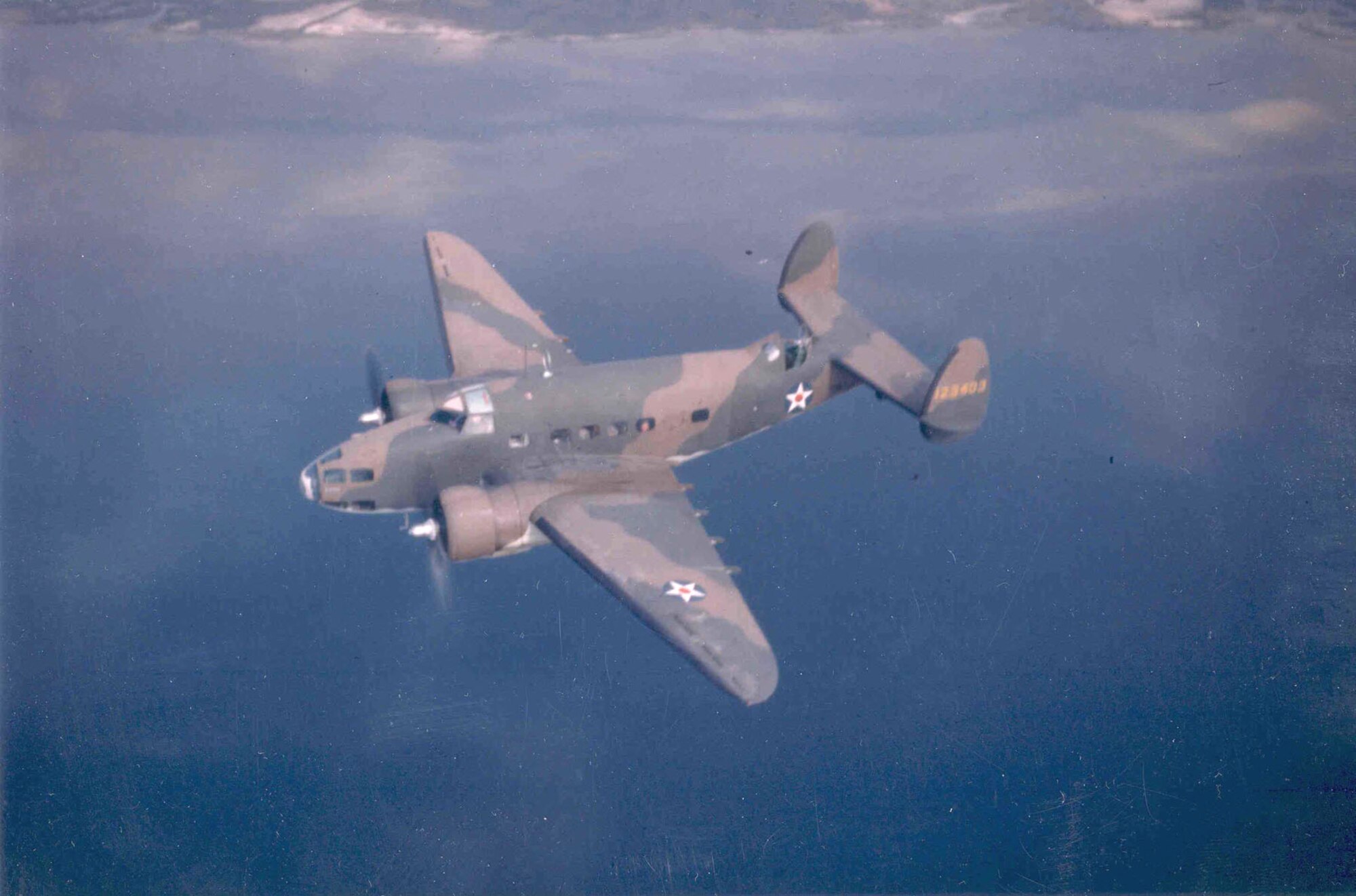 A U.S. Army Air Forces Lockheed A-29, serial number 41-23403, is seen here in flight over the ocean in this picture taken sometime in the early period of World War II.  The camouflage scheme and colors on this former Lend-Lease contracted aircraft are of British origin.  In May, 1942, instructions were issued to remove the red circle in the middle of the national insignia on all US aircraft.  (USAF Photo)