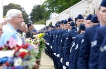 U.S. Air Force Airmen march away after handing wreaths to designated wreath bearers during a Memorial Day ceremony May 25, 2015, at the Cambridge American Cemetery and Memorial in Cambridge, England. The wreaths were given in remembrance of service members who died during World War II. (U.S. Air Force photo by Senior Airman Kate Thornton/Released)