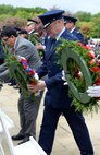 U.S. Air Force Brig. Gen. Douglas A. Cox, U.S. Air Forces in Europe-United Kingdom director lays a wreath at the Tablets of the Missing during the annual Memorial Day Observance at the Cambridge American Cemetery and Memorial in Cambridge, England, May 25, 2015. The Tablets of the Missing contain more than 5,126 names of service members missing in action, lost or buried at sea, or unknown. (U.S. Air Force photo by Senior Airman Christine Halan/Released)
