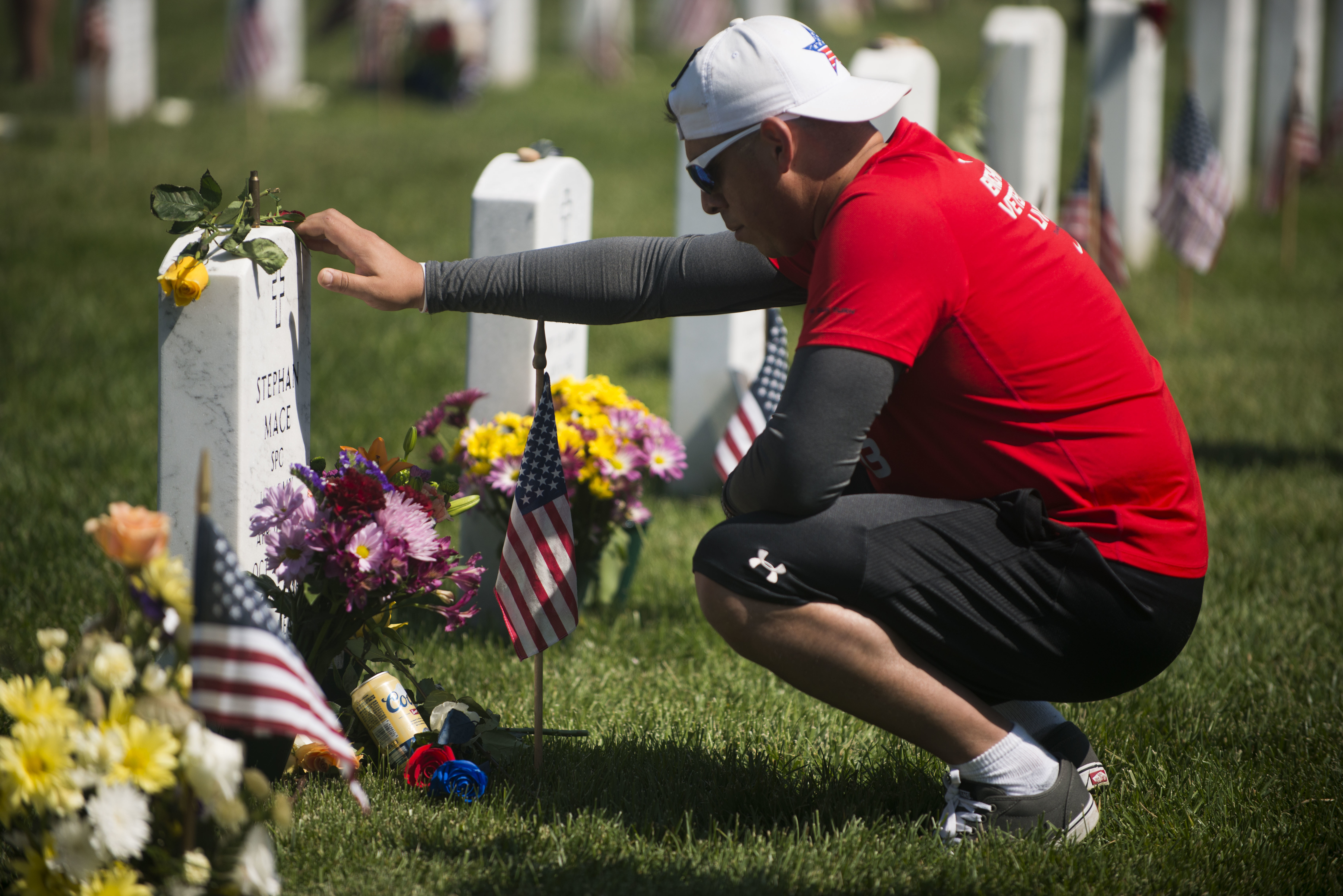 Larry Gonzales visits the grave of Army Spc. Stephen Mace on Memorial