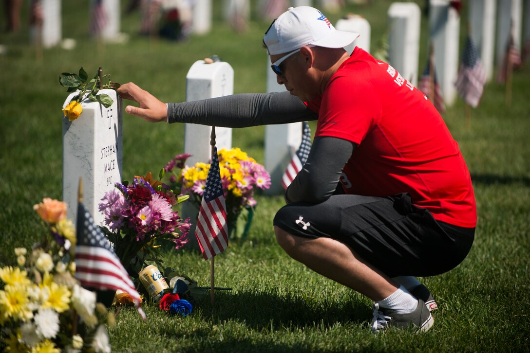 Larry Gonzales visits the grave of Army Spc. Stephen Mace on Memorial Day in Section 60 at Arlington National Cemetery in Arlington, Va., May 25, 2015.  
