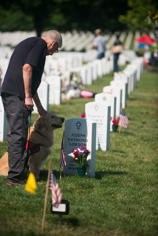 Cal Copp, left, and Lily visit the grave o Army Master Sgt. Joseph Gordon on Memorial Day  in Section 60 at Arlington National Cemetery in Arlington, Va., May 25, 2015. Copp called  Gordon his “best friend” and said they had known each other since they were children. 