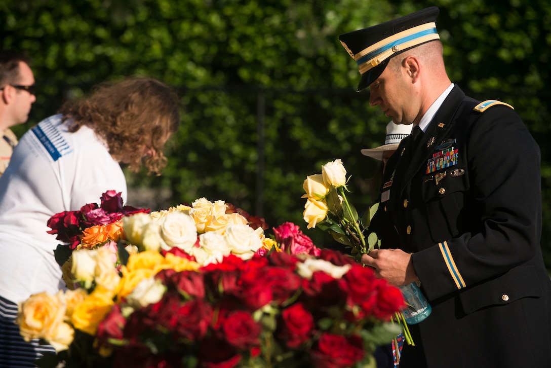 U.S. Army 1st Lt. John Rhoten picks up roses at Arlington National Cemetery’s Welcome Center in Arlington, Va., May 25, 2015. Rhoten is assigned to the 11th Armored Cavalry Regiment.