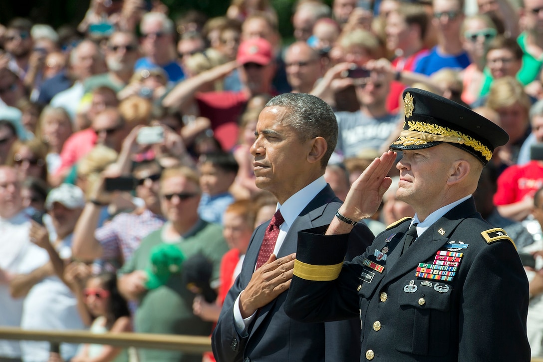 President Barack Obama places his hand over his heart before laying a wreath at the Tomb of the Unknown Soldier to observe Memorial Day at Arlington National Cemetery in Arlington, Va., May 25, 2015.