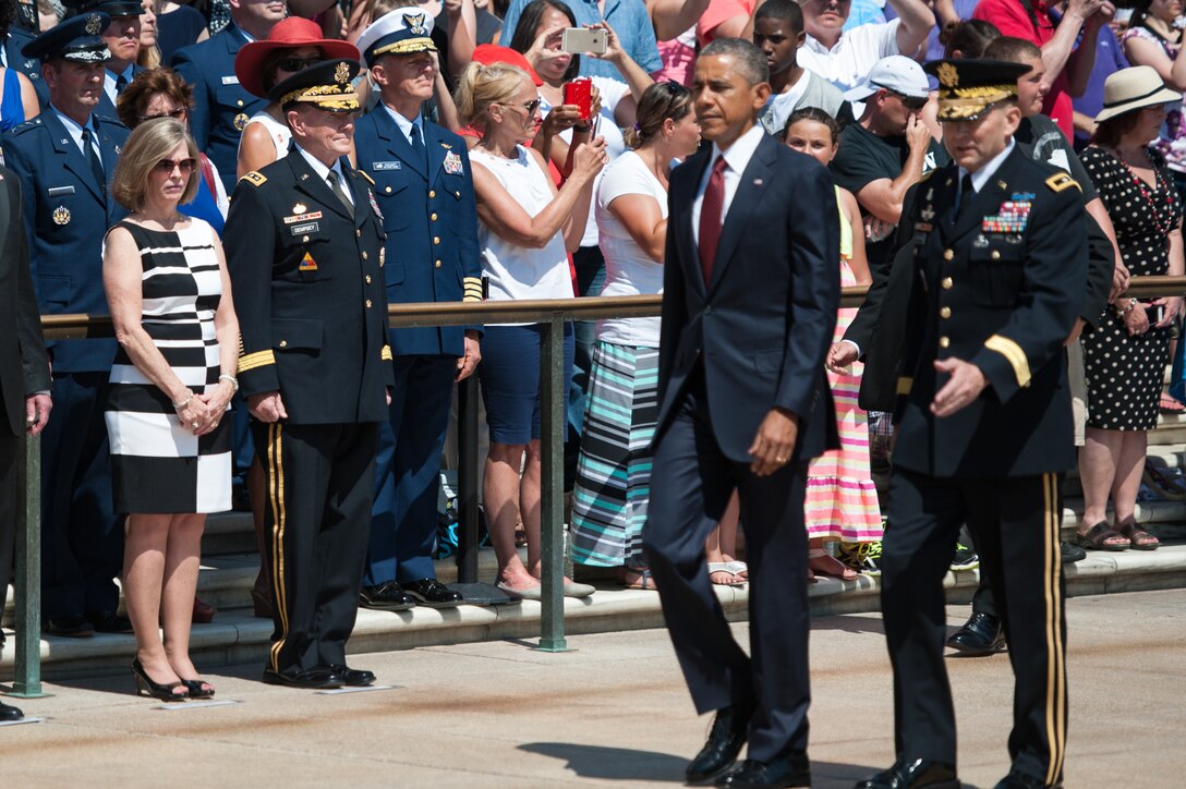 Army Gen. Martin E. Dempsey, left, chairman of the Joint Chiefs of Staff, and his wife, Deanie, stand as President Barack Obama, accompanied by Army Maj. Gen. Jeffrey S. Buchanan, commander of the U.S. Army Military District of Washington, prepare to lay a wreath at the Tomb of the Unknown Soldier, at Arlington National Cemetery in Arlington,Va., on Memorial Day, Monday, May 25, 2015.