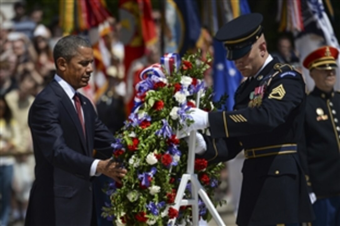 President Barack Obama lays a wreath at the Tomb of the Unknown Soldier to observe Memorial Day at Arlington National Cemetery in Arlington, Va., May 25, 2015.