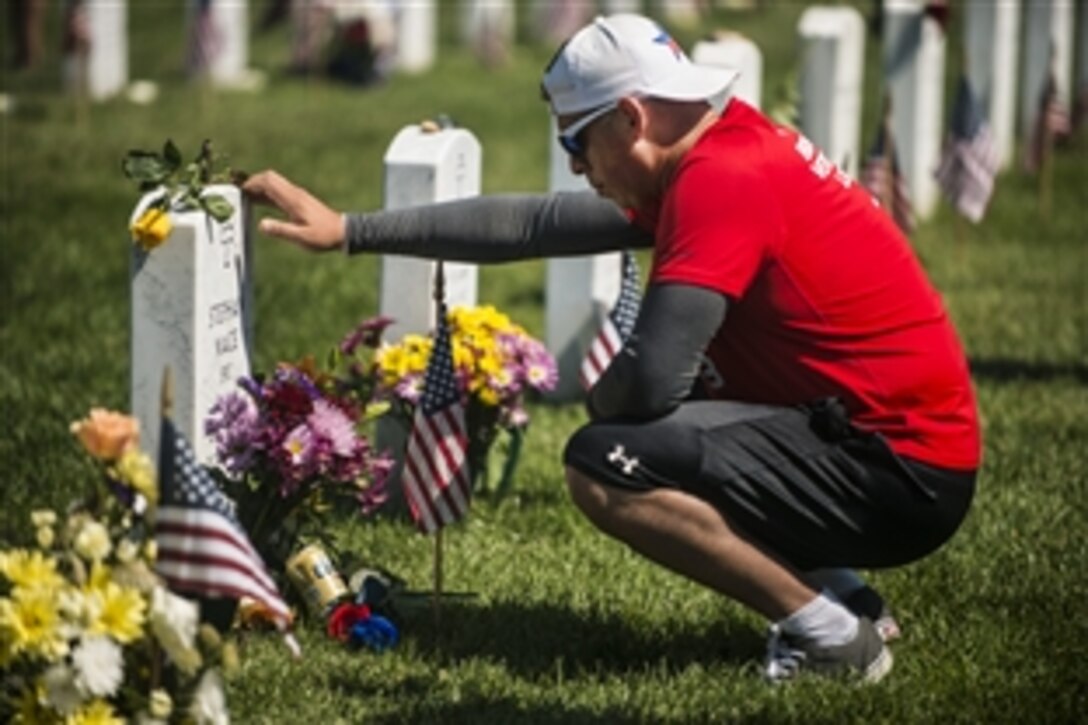 Larry Gonzales visits the grave of Army Spc. Stephen Mace on Memorial Day in Section 60 at Arlington National Cemetery in Arlington, Va., May 25, 2015. 