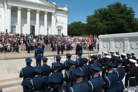 President Barack Obama, accompanied by Army Maj. Gen. Jeffrey S. Buchanan, commander of the U.S. Army Military District of Washington, renders honors during the playing of the national anthem before laying a wreath at the Tomb of the Unknown Soldier at Arlington National Cemetery in Arlington, Va., on Memorial Day, May 25, 2015.
