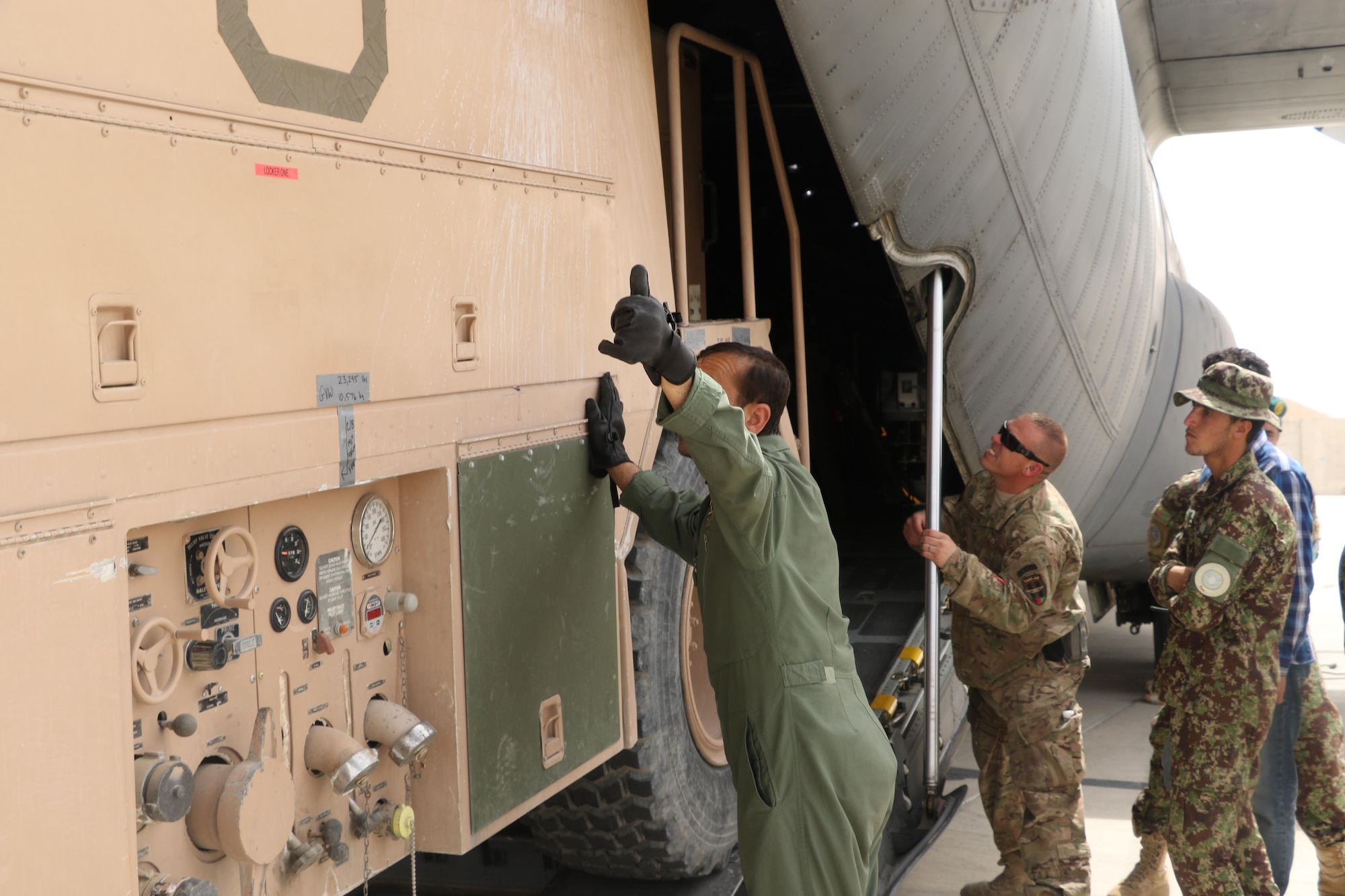 Afghan Air Force loadmasters along with Train, Advise, Assist Command - Air advisers safely loaded a P-19 firetruck onto an Afghan Air Force C-130 at Kandahar Air Wing, May 6, 2015. The team transported the firetruck from Kandahar to Herat to meet a critical need and creating an organic firefighting capability at the new location. (Courtesy photo)