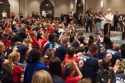 18th Chairman of the Joint Chiefs of Staff Gen. Martin E. Dempsey sings to surviving children at the 21st annual T.A.P.S. National Military Survivor Seminar and Good Grief Camp for Young Survivors, in Arlington, Va., May 22, 2015. Gen. Dempsey addressed surviving family members of fallen service members from both behind a podium and behind a microphone as he sang a few songs.