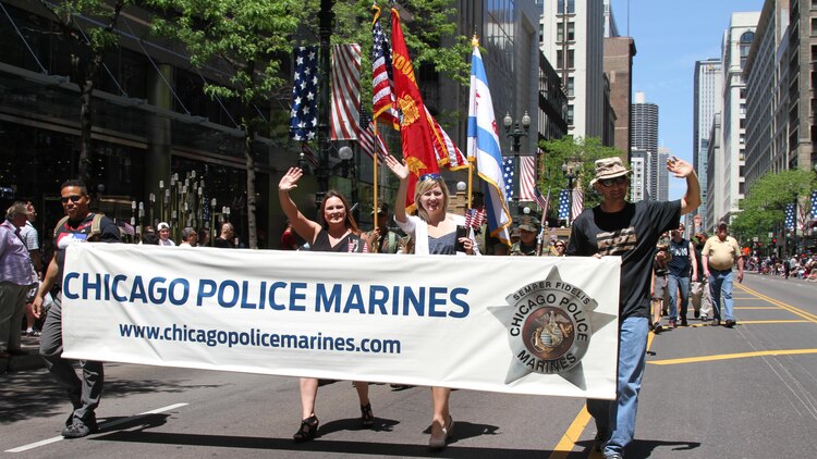 Gold Star families and members of the Chicago Police Marines approach the reviewing area during the Chicago Memorial Day Parade May 23, 2015 in Chicago, Illinois. The annual parade is considered one of the largest in the nation and attracts thousands of visitors each year to remember those who have paid the ultimate sacrifice for American freedom.