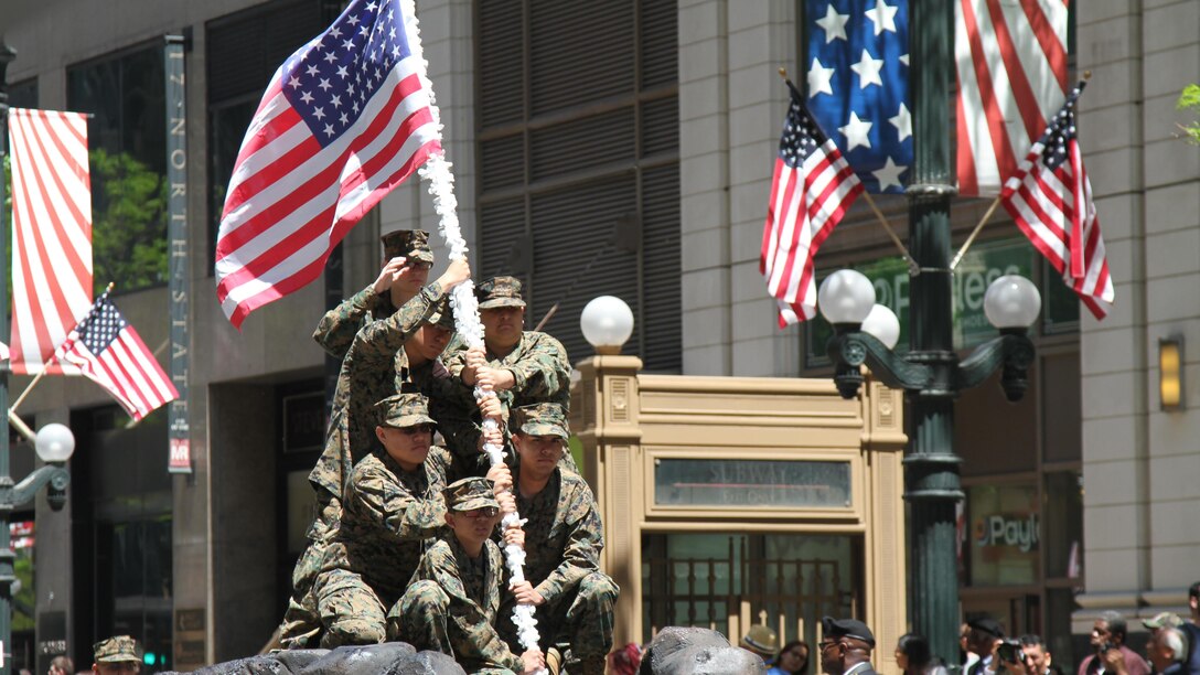 Junior Reserve Officer Training Corps students recreate the flag raising on Mount Suribachi as part of their float during the 2015 Chicago Memorial Day Parade May 23, 2015 in Chicago, Illinois. The annual parade is considered one of the largest in the nation and attracts thousands of visitors each year to remember those who have paid the ultimate sacrifice for American freedom.