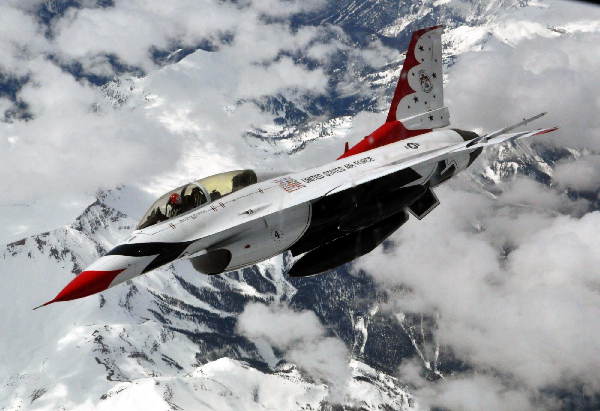 Maj. Curtis Doughtery, slot pilot for the U.S. Air Force Thunderbirds Air Demonstration Squadron, banks right over the Rocky Mountains after being refueled in flight by a KC-135 Stratotanker from McConnell Air Force Base, Kan., May 21, 2015. The KC-135 was one of two McConnell tankers providing cross-country air refueling support for the Thunderbirds. The KC-135 aircrews, all Air Force Reservists from the 931st Air Refueling Group, provided several air refuelings for the Thunderbirds, taking them from Nellis AFB, Nev., to Long Island MacArthur Airport, Islip, N.Y., ensuring the demonstration team made it to their May 23 flight demonstration at the Jones Beach Air Show in Wantagh, N.Y. (U.S. Air Force photo by Capt. Zach Anderson) 