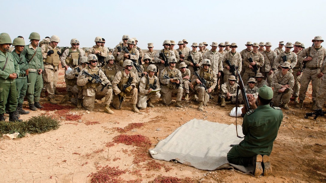 A platoon leader with Morocco’s 6th Infantry Brigade instructs Marines on the assembly and disassembly of the AK-47 during the first day of African Lion 15, May 15, 2015. Marines with Alpha and Bravo Company, 1st Battalion, 25th Marine Regiment spent the day conducting marksmanship training and integrated weapons exchange with the Moroccan soldiers, focusing on the M4 and the AK-47. 