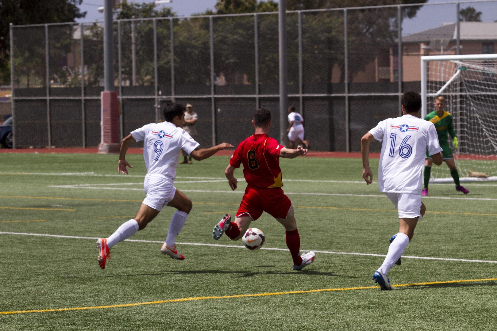 An All-Marine soccer player defends against members of the Air Force soccer team May 18 during the 2015 Armed Forces Soccer Championship at Marine Corps Air Station Miramar, Calif. All teams were evenly matched prior to the day's game.
