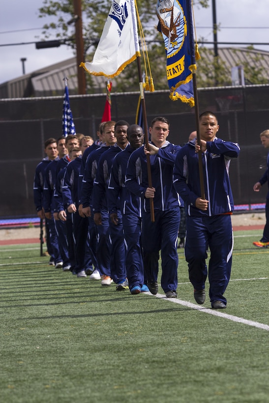 Members of the combined U.S. Navy and U.S. Coast Guard soccer team march onto the field during the opening ceremony of the 2015 Armed Forces Soccer Championship May 14 at Marine Corps Air Station Miramar, Calif. Service members from each branch came to Miramar to compete in the championship.