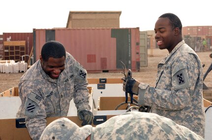 Army Staff Sgt. Cordell Frazier, a team leader with the 319th Transportation Company, 110th Combat Sustainment Support Battalion, 224th Sustainment Brigade, 103rd Sustainment Command (Expeditionary), and Army Spc. Josh Goodman, a Mobile Redistribution Team yard worker with the 319th Trans. Co., sort and inventory bulk wires Dec. 13, 2010 at the MRT fixed site yard on Contingency Operating Base Adder, Iraq.