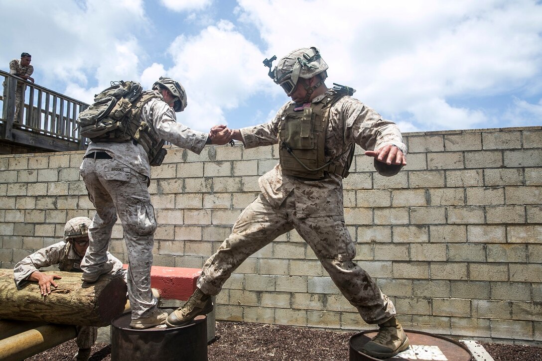 U.S. Marines with the 15th Marine Expeditionary Unit’s Maritime Raid Force work together to complete an obstacle at a leadership reaction course aboard Marine Corps Base Hawaii, May 18, 2015. All of the obstacles required a great amount of teamwork and initiative, building the Marines leadership skills and confidence in each other’s leadership abilities. (U.S. Marine Corps photo by Cpl. Anna Albrecht/Released)