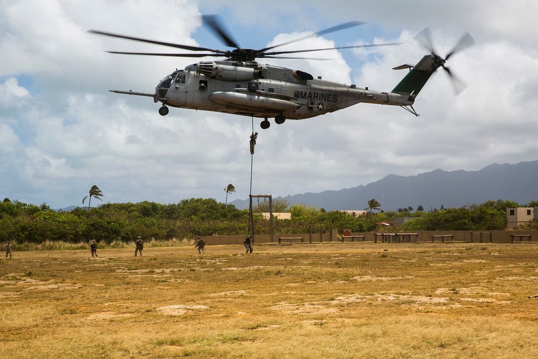 U.S. Marines with the 15th Marine Expeditionary Unit’s Maritime Raid Force security element fast rope out of a CH-53E Super Stallion aboard Marine Corps Base Hawaii, May 12, 2015. Fast roping gives the MRF the ability to rapidly insert combat forces onto an objective. (U.S. Marine Corps photo by Cpl. Anna Albrecht/Released)