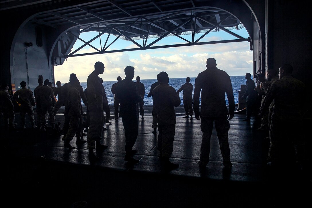 U.S. Marines and Sailors with the 15th Marine Expeditionary Unit and Essex Amphibious Ready Group practice Marine Corps Martial Arts Program drills in the hangar bay of the USS Essex (LHD 2) at sea in the Pacific Ocean, May 23, 2015. The Marines and Sailors are working toward their next MCMAP level belt during their seven-month deployment through the Pacific and Central command areas. (U.S. Marine Corps photo by Cpl. Elize McKelvey/Released)