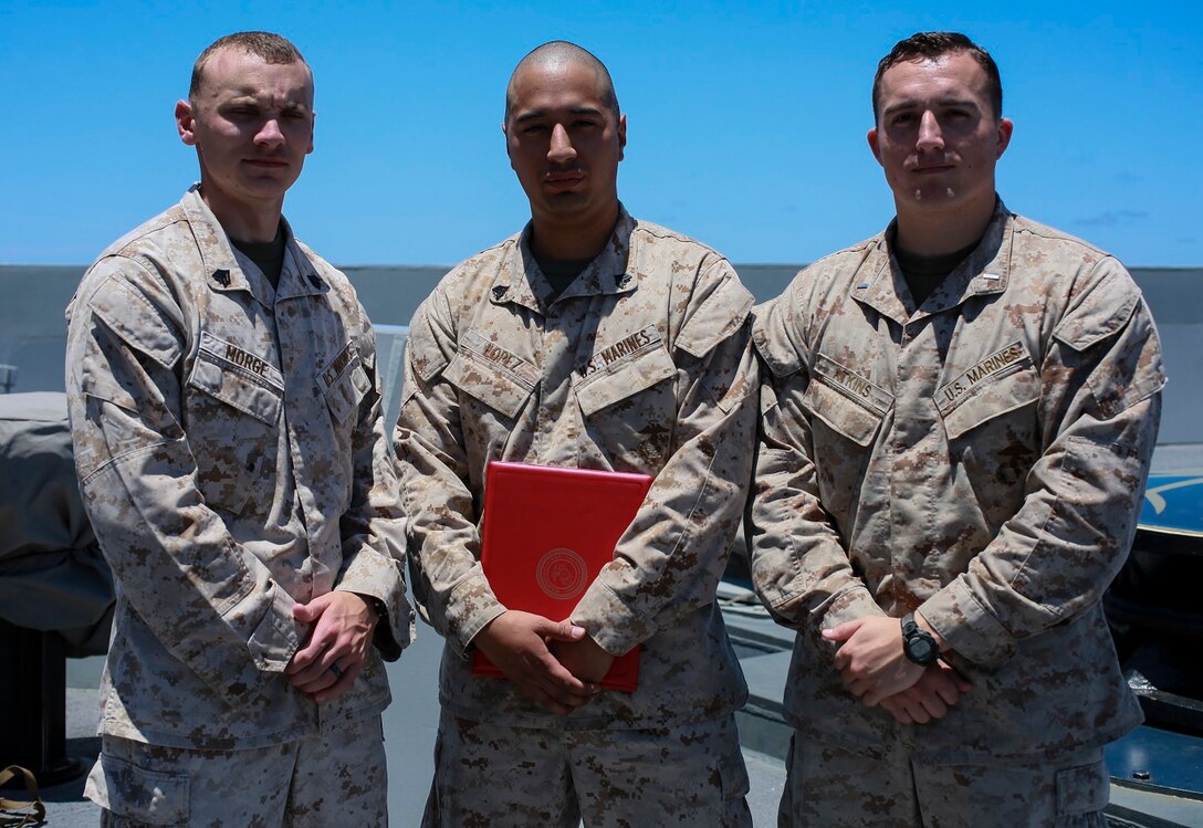 U.S. Marines Sgt. Caleb Morge, left, Sgt. Jose A Lopez, center, and 1st Lt. Dennis Atkins pose for a photo after Lopez’s promotion ceremony aboard the USS Anchorage (LPD-23) at sea in the Pacific Ocean, May 21, 2015. (U.S. Marine Corps photo by Cpl. Steve H. Lopez/Released)