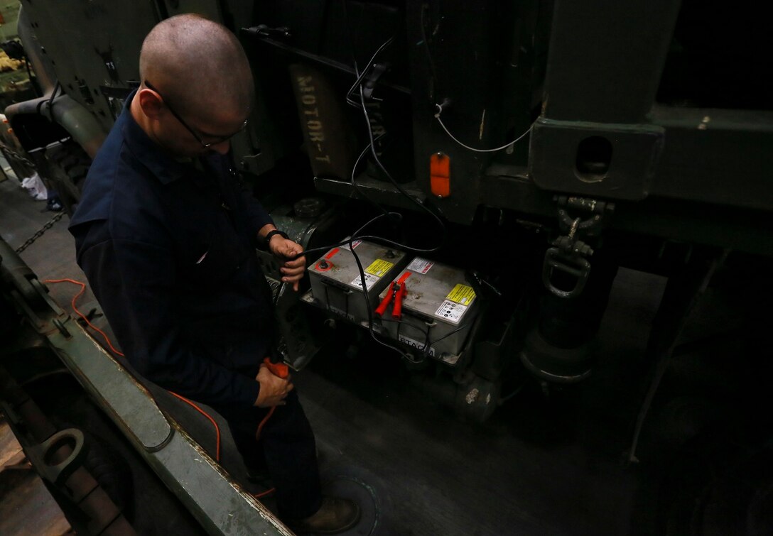 U.S. Marine Cpl. Benjamin E. Tingle charges a dead battery with a pulse charger for a Medium Tactical Vehicle Replacement (MTVR) aboard the USS Anchorage (LPD-23) at sea in the Pacific Ocean, May 15, 2015. Tingle is a motor transportation mechanic with Combat Logistics Battalion, 15th Marine Expeditionary Unit. The Marines and Sailors of the 15th MEU constantly perform maintenance on their equipment to maintain combat readiness. (U.S. Marine Corps photo by Cpl. Steve H. Lopez/Released)