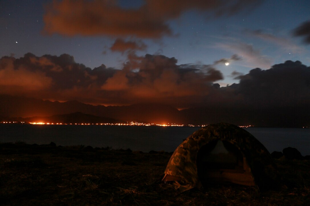 U.S. Marines with Combat Logistics Battalion 15, 15th Marine Expeditionary Unit, set up camp for the night after training aboard Bellows Air Force Station Hawaii, May 19, 2015. Marines conducted multiple training evolutions in Hawaii to prepare for the remainder of their deployment. (U.S. Marine Corps photo by Cpl. Steve H. Lopez/Released)