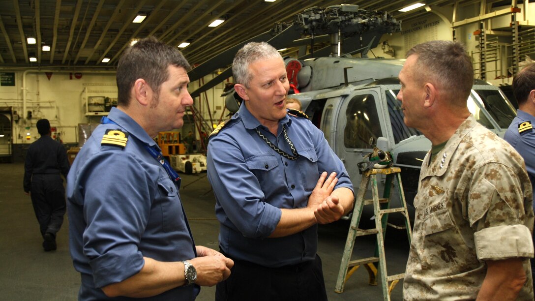 U.S. Marine Corps Lt. Gen. Jon Davis, Deputy Commandant for Aviation (right), talks with Royal Navy Cmdr. Mark Dellar and Lt. Cmdr. Jim Cobbert, while embarked aboard USS Wasp May 20, 2015, during the first phase of F-35B operational testing.  Over a two-week period, OT-1 will evaluate the full spectrum of F-35B measures of suitability and effectiveness, as well as the aircraft’s readiness for initial operating capability in July 2015. Data and lessons learned will lay the groundwork for future F-35B deployments aboard U.S. Navy amphibious carriers. Sixteen Royal Navy and Royal Air Force personnel are participating in OT-1 in order to glean experience and take back lessons learned for the UK’s F-35B program.