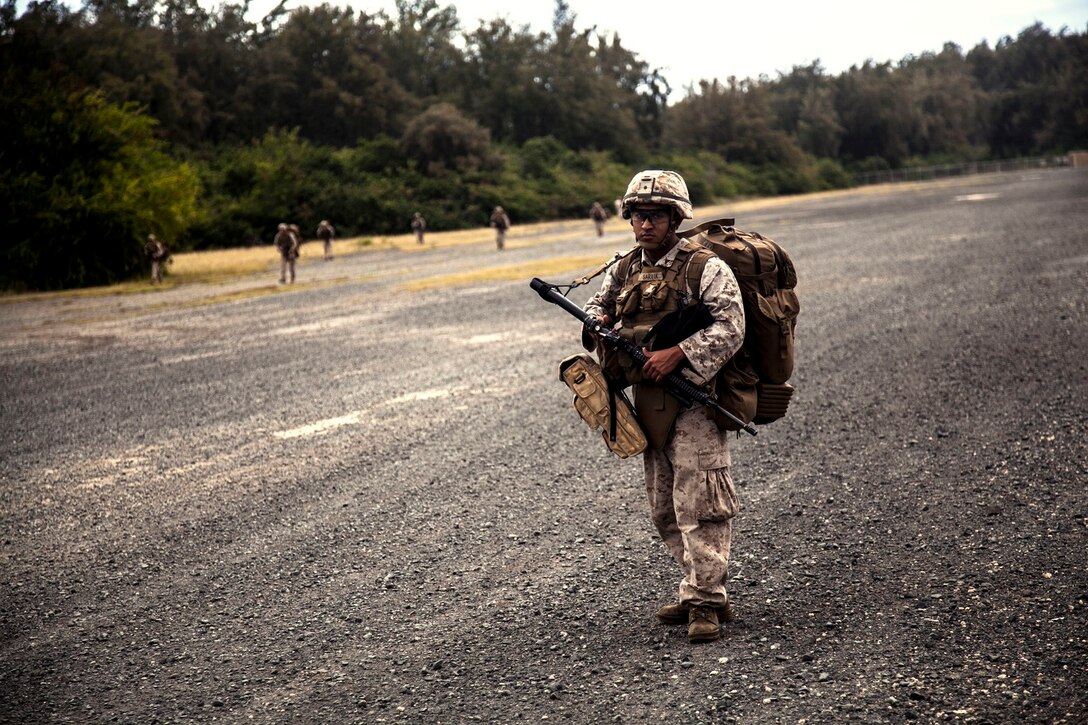 U.S. Marines with Lima Company, Battalion Landing Team 3rd Battalion, 1st Marine Regiment, 15th Marine Expeditionary Unit, patrol aboard Bellows Air Force Station, Hawaii, May 17, 2015. The Marines with the 15th MEU continue to maintain combat readiness during their seven-month deployment through the Pacific and Central Command areas. (U.S. Marine Corps photo by Cpl. Elize McKelvey/Released)