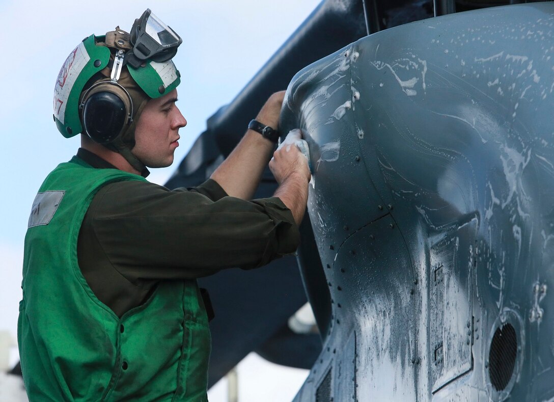 U.S. Marine Cpl. Jared Odom scrubs an AH-1Z Viper aboard the USS Anchorage (LPD-23) at sea in the Pacific Ocean, May 17, 2015. Odom is an airframe mechanic with Marine Medium Tiltrotor Squadron 161 (Reinforced), 15th Marine Expeditionary Unit. The Marines of the 15th MEU’s aviation combat element keep their aircraft clean and ready for combat. (U.S. Marine Corps photo by Cpl. Steve H. Lopez/Released