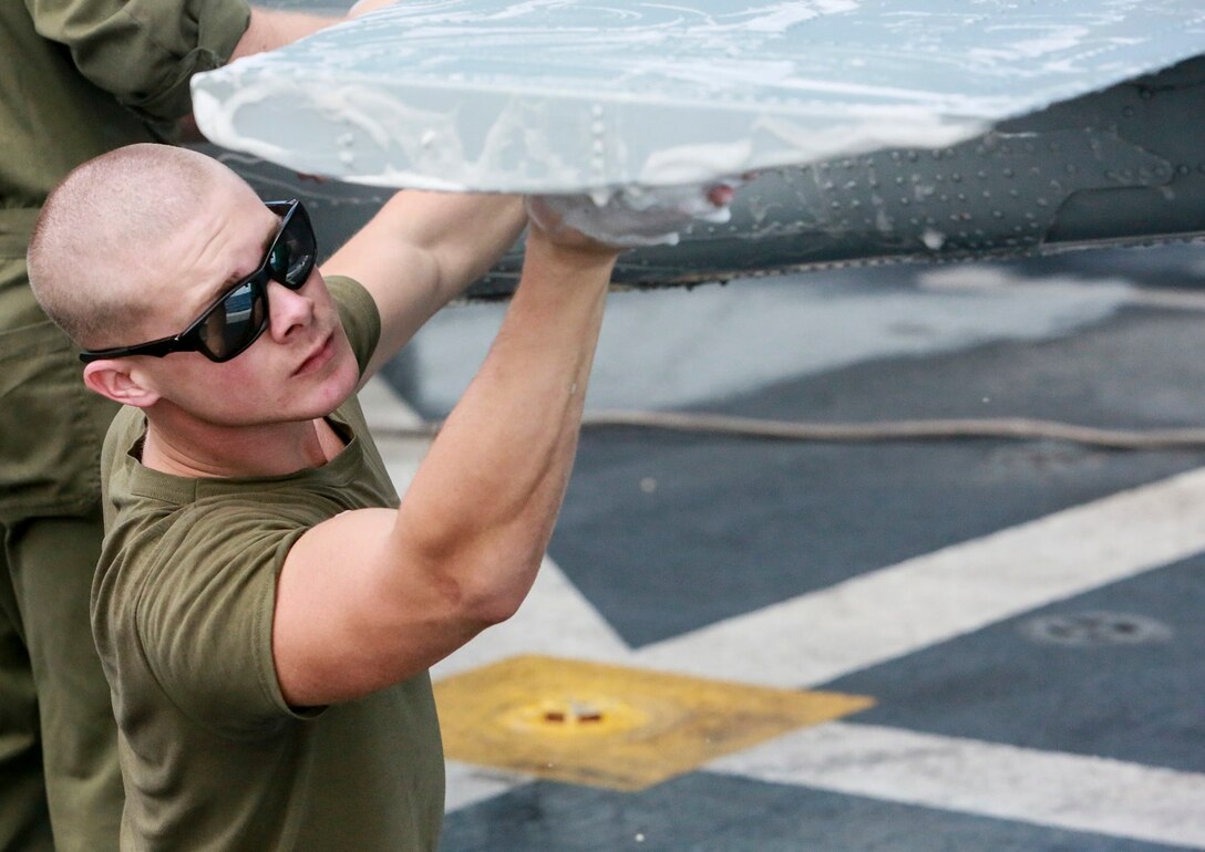 U.S. Marine Lance Cpl. Kevin Freeman scrubs an AH-1Z Viper aboard the USS Anchorage (LPD-23) at sea in the Pacific Ocean, May 17, 2015. Freeman is an airframe mechanic with Marine Medium Tiltrotor Squadron 161 (Reinforced), 15th Marine Expeditionary Unit. The Marines of the 15th MEU’s aviation combat element keep their aircraft clean and ready for combat. (U.S. Marine Corps photo by Cpl. Steve H. Lopez/Released)