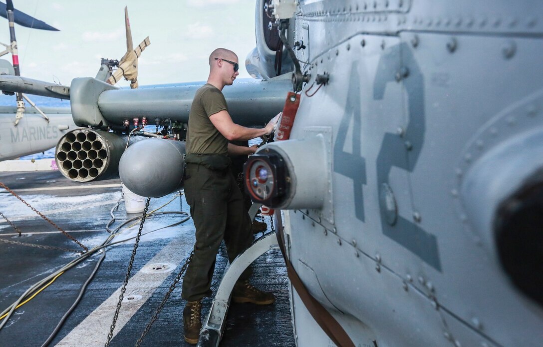 U.S. Marine Lance Cpl. Kevin Freeman scrubs an AH-1Z Viper aboard the USS Anchorage (LPD-23) at sea in the Pacific Ocean, May 17, 2015. Freeman is an airframe mechanic with Marine Medium Tiltrotor Squadron 161 (Reinforced), 15th Marine Expeditionary Unit. The Marines of the 15th MEU’s aviation combat element keep their aircraft clean and ready for combat. (U.S. Marine Corps photo by Cpl. Steve H. Lopez/Released)