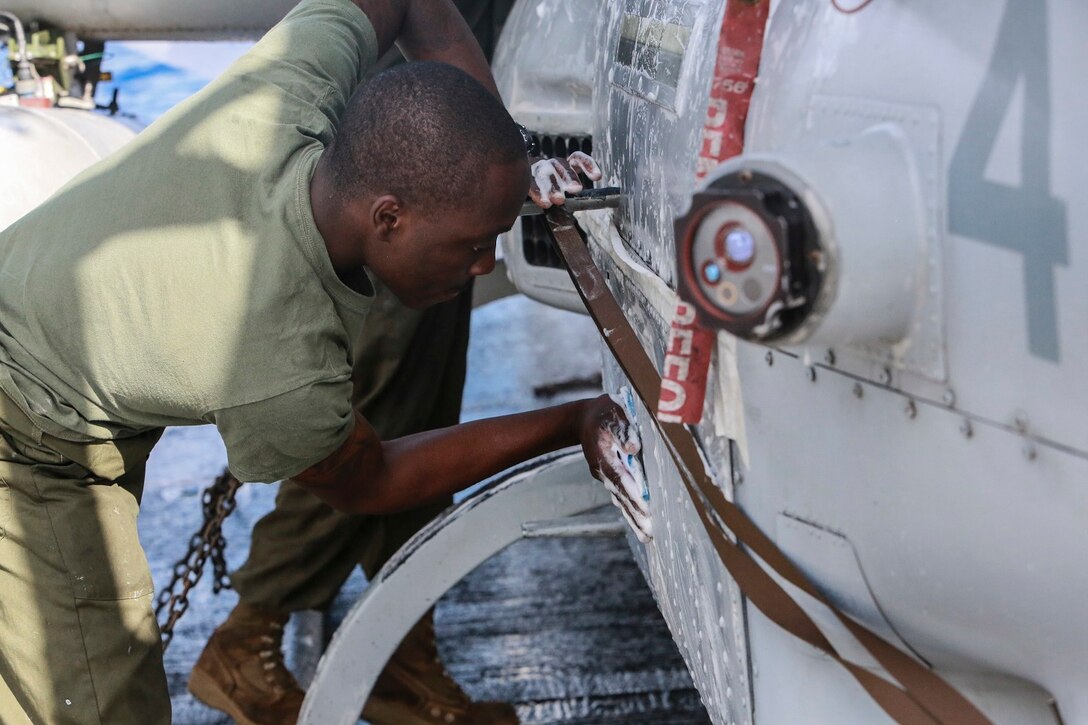 U.S. Marine Lance Cpl. Zion Song scrubs an AH-1Z Viper aboard the USS Anchorage (LPD-23) at sea in the Pacific Ocean, May 17, 2015. Song is an airframe mechanic with Marine Medium Tiltrotor Squadron 161 (Reinforced), 15th Marine Expeditionary Unit. The Marines of the 15th MEU’s aviation combat element keep their aircraft clean and ready for combat. (U.S. Marine Corps photo by Cpl. Steve H. Lopez/Released)