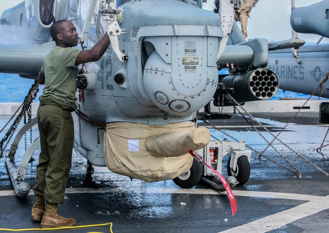 U.S. Marine Lance Cpl. Zion Song scrubs an AH-1Z Viper aboard the USS Anchorage (LPD-23) at sea in the Pacific Ocean, May 17, 2015. Song is an airframe mechanic with Marine Medium Tiltrotor Squadron 161 (Reinforced), 15th Marine Expeditionary Unit. The Marines of the 15th MEU’s aviation combat element keep their aircraft clean and ready for combat. (U.S. Marine Corps photo by Cpl. Steve H. Lopez/Released)