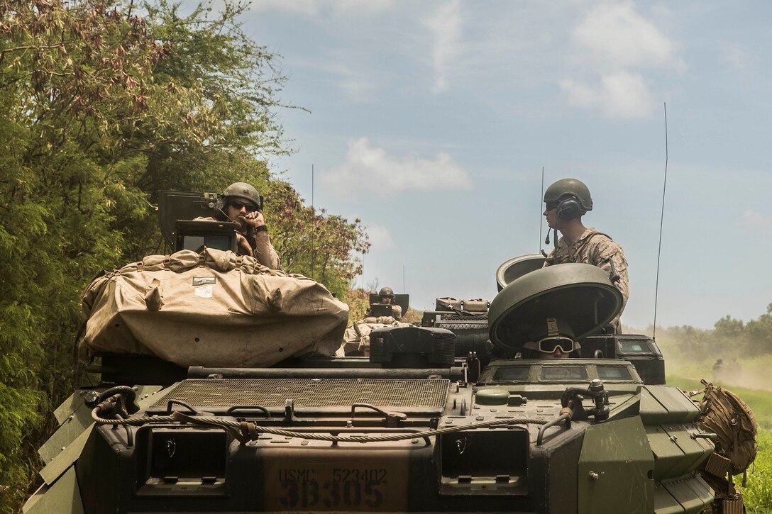U.S. Marines with amphibious assault platoon transport Marines with Kilo Company, Battalion Landing Team 3rd Battalion, 1st Marine Regiment, 15th Marine Expeditionary Unit, aboard Marine Corps Base Hawaii, May 19, 2015. During the training, Marines rehearsed amphibious troop transport using AAV-7 Amphibious Assault Vehicles. (U.S. Marine Corps photo by Sgt. Emmanuel Ramos/Released)