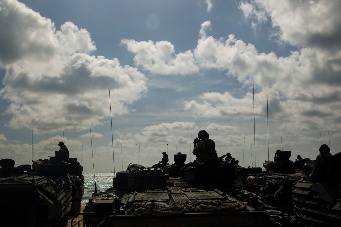 U.S. Marines with with Kilo Company, Battalion Landing Team 3rd Battalion, 1st Marine Regiment, 15th Marine Expeditionary Unit, stage to return to the USS Rushmore (LSD 47) from Marine Corps Base Hawaii, May 19, 2015. During the training, Marines rehearsed amphibious troop transport using AAV-7 Amphibious Assault Vehicles. (U.S. Marine Corps photo by Sgt. Emmanuel Ramos/Released)
