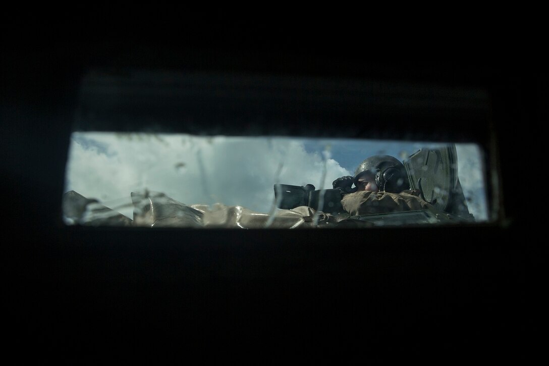U.S. Marine 1st Lt. Connor Murphy observes his platoon’s maneuver during an amphibious movement to the USS Rushmore (LSD 47) aboard Marine Corps Base Hawaii, May 19, 2015. Murphy is the platoon commander for the amphibious assault platoon with Battalion Landing Team 3rd Battalion, 1st Marine Regiment, 15th Marine Expeditionary Unit. During the training, Marines rehearsed amphibious troop transport using AAV-7 Amphibious Assault Vehicles. (U.S. Marine Corps photo by Sgt. Emmanuel Ramos/Released)