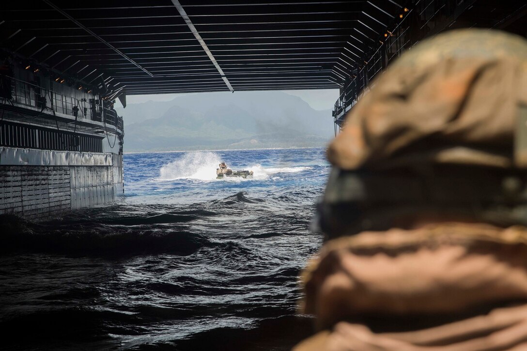 U.S. Marines with Kilo Company, Battalion Landing Team 3rd Battalion, 1st Marine Regiment, 15th Marine Expeditionary Unit, prepare to board the USS Rushmore (LSD 47), May 19, 2015. During the training, Marines rehearsed amphibious troop transport using AAV-7 Amphibious Assault Vehicles. (U.S. Marine Corps photo by Sgt. Emmanuel Ramos/Released)