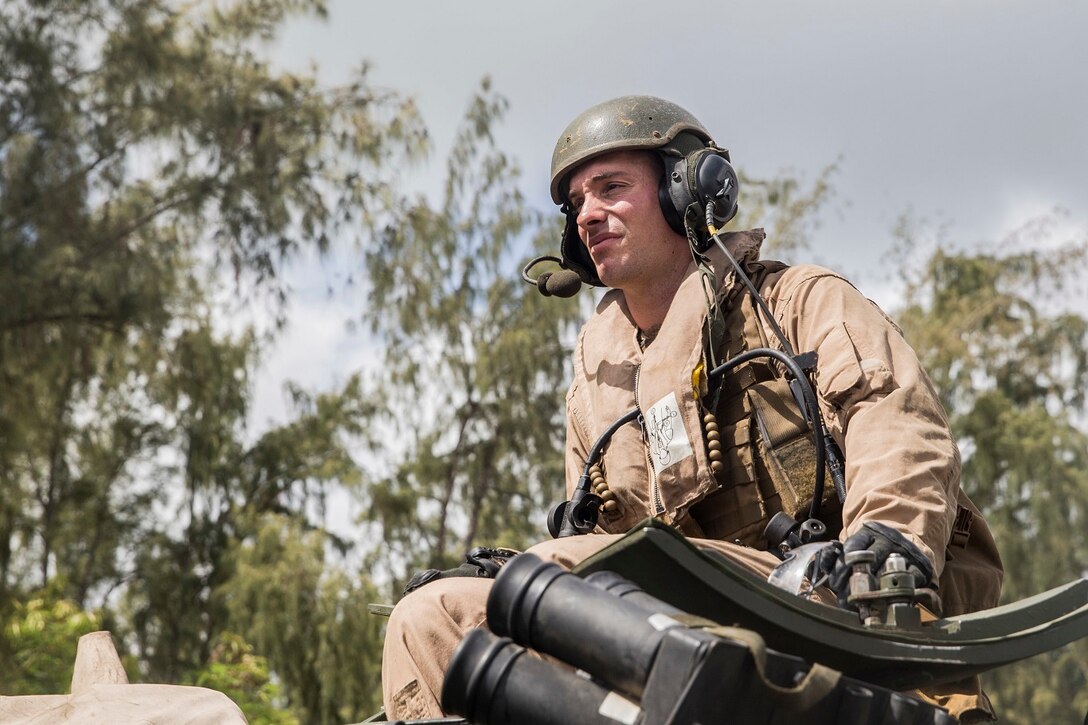 U.S. Marine 1st Lt. Connor Murphy observes his platoon set into place during an amphibious movement from the USS Rushmore (LSD 47) aboard Marine Corps Base Hawaii, May 19, 2015. Murphy is the platoon commander for the amphibious assault platoon with Battalion Landing Team 3rd Battalion, 1st Marine Regiment, 15th Marine Expeditionary Unit. During the training, Marines rehearsed amphibious troop transport using AAV-7 Amphibious Assault Vehicles. (U.S. Marine Corps photo by Sgt. Emmanuel Ramos/Released)