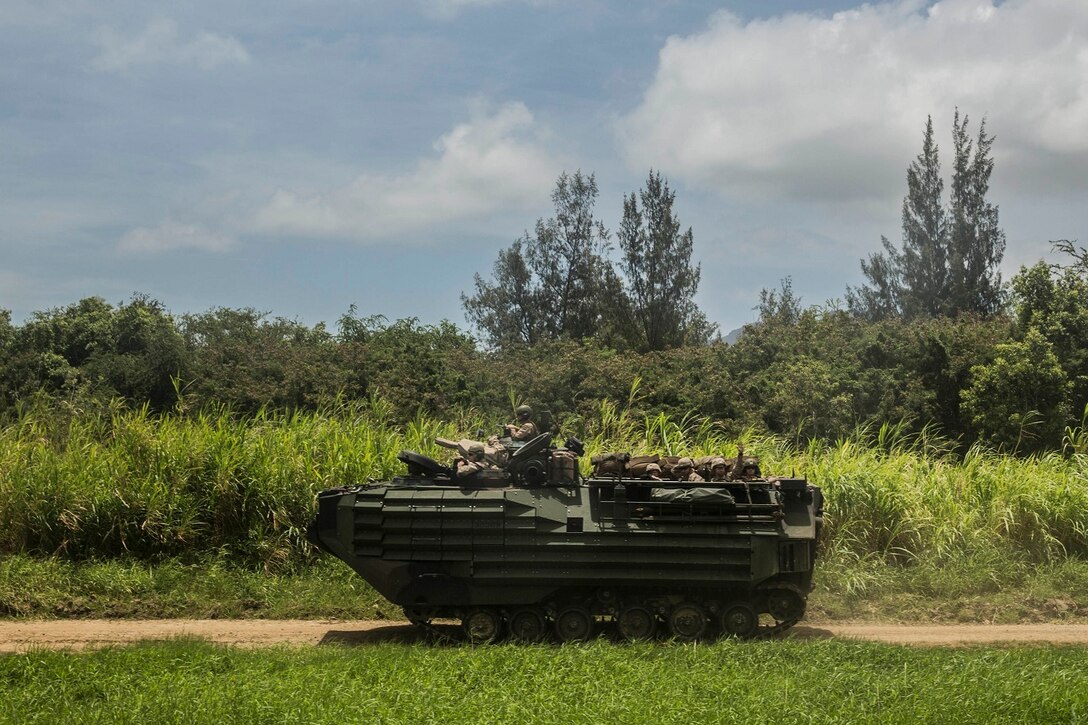 U.S. Marines with amphibious assault platoon transport Marines with Kilo Company, Battalion Landing Team 3rd Battalion, 1st Marine Regiment, 15th Marine Expeditionary Unit, aboard Marine Corps Base Hawaii, May 19, 2015. During the training, Marines rehearsed amphibious troop transport using AAV-7 Amphibious Assault Vehicles. (U.S. Marine Corps photo by Sgt. Emmanuel Ramos/Released)