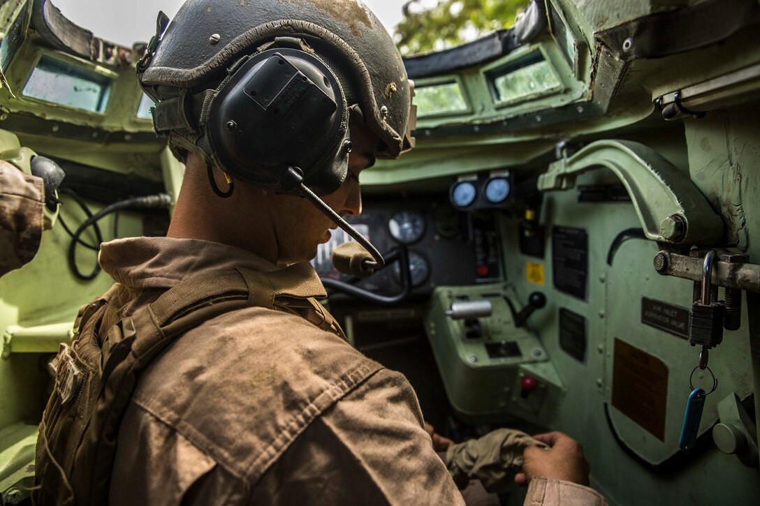 U.S. Marine Cpl. Christopher Jimerson prepares to transport troops using an using AAV-7 Amphibious Assault Vehicle aboard Marine Corps Base Hawaii, May 19, 2015. Jimerson is a crew chief with Kilo Company, Battalion Landing Team 3rd Battalion, 1st Marine Regiment, 15th Marine Expeditionary Unit. The training focused on amphibious and tactical troop transport. (U.S. Marine Corps photo by Sgt. Emmanuel Ramos/Released)