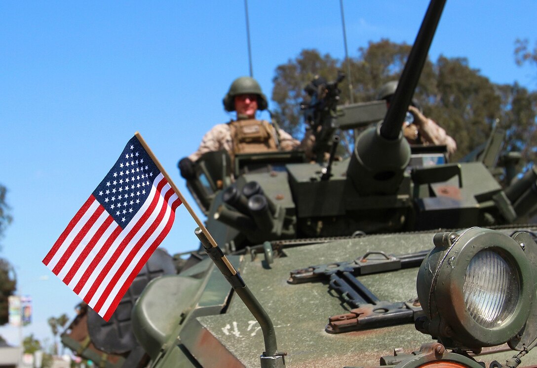 Marines with Light Armored Reconnaissance Battalion, I Marine Expeditionary Force, display the national colors on their LAV-25 light armored vehicle during the 56th annual Armed Forces Day Parade in Torrance, Calif., May 16, 2015. The Marine Corps contributed a marching element of approximately 30 Marines, LAV-25 light armored vehicles, an M777 Howitzer, and a medium tactical vehicle to the parade and used the opportunity to represent the Marine Corps in the community and share their pride. (U.S. Marine Corps photo by Lance Cpl. Caitlin Bevel)