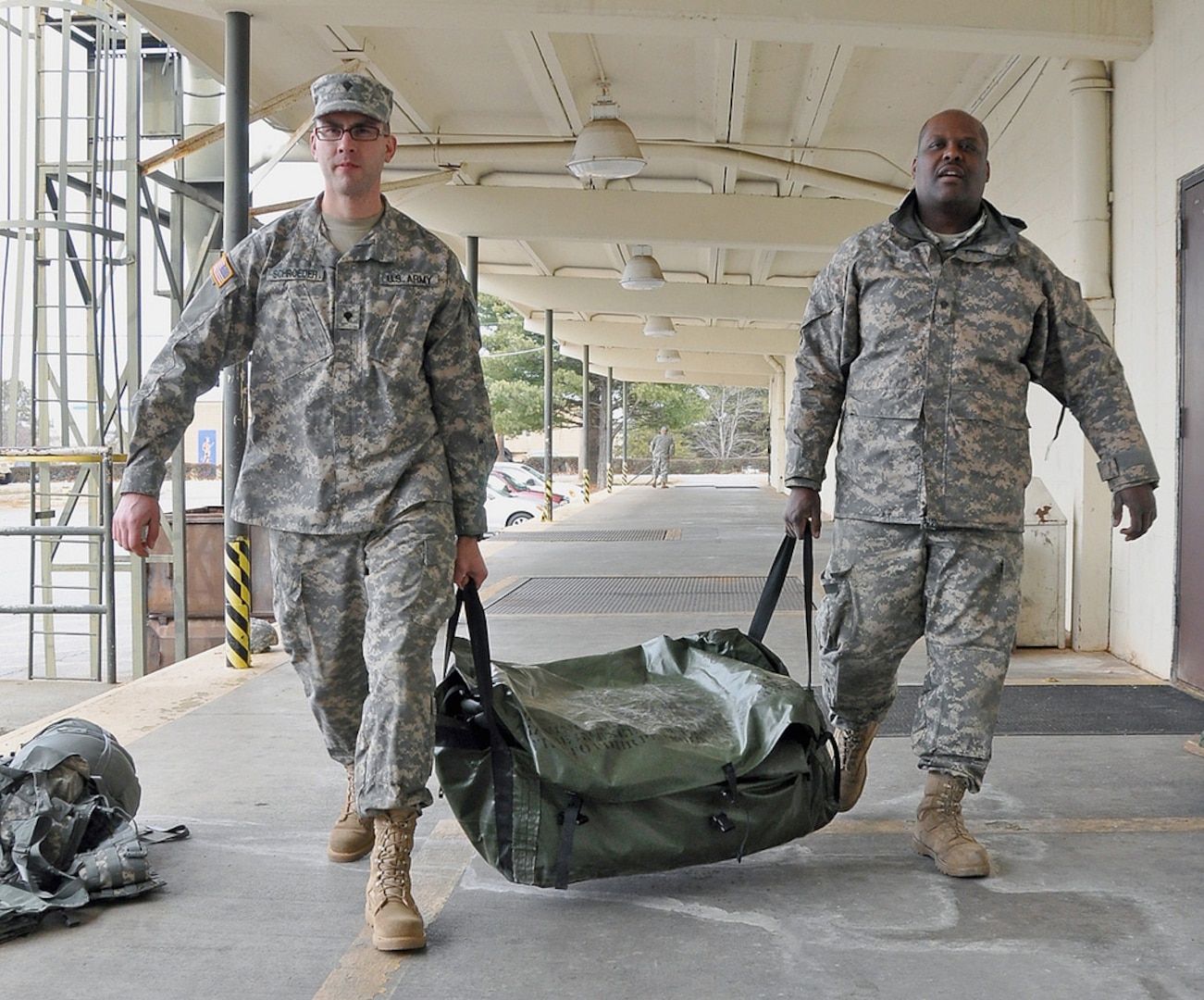 Army Spcs. Adam Schroeder (left) and Bernard Satchell, both with the Georgia National Guard’s 124th Mobile Public Affairs Detachment, preposition the unit’s tents to house unit members should they be called out to assist during the storm expected to hit Georgia today.