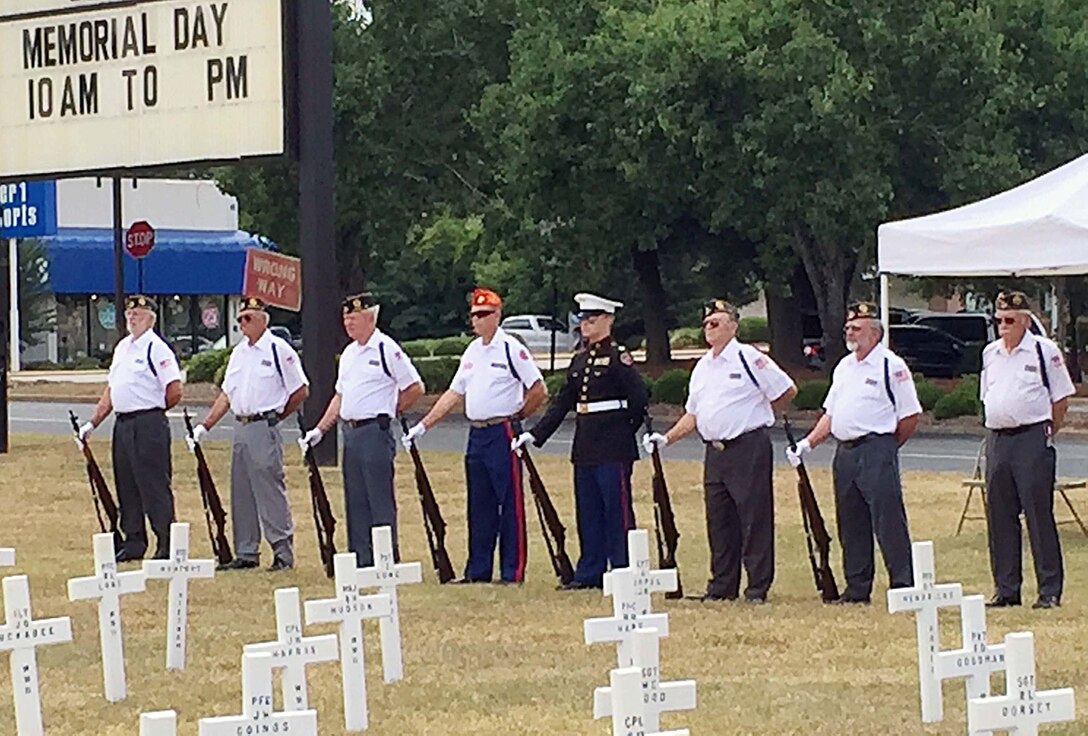 Members of the Albany, Ga., community conduct a Field of Crosses Memorial Day ceremony in front of the Albany Mall, May 24. After giving a brief history of Memorial Day, Sgt. Maj. Joseph Davenport, sergeant major, Marine Corps Logistics Command, told those gathered that Memorial Day is the ultimate American holiday often confused with Veterans Day. "It is a day often used by retail establishments as a sales day; by sports fans for races such as the Indy 500 and Coca-Cola 600 and so on. But if you ask a veteran or a family member, they will tell you it represents something else. John 15:15 says, ‘Greater love hath no man than this, that a man lay down his life for his friends.’ So tomorrow at 3 p.m., please pause for a national moment of remembrance to honor that fallen warrior for his or her sacrifice," he said.