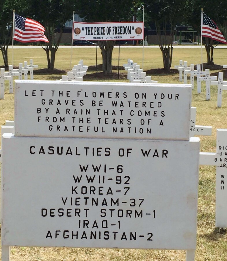 Members of the Albany, Ga., community conduct a Field of Crosses Memorial Day ceremony in front of the Albany Mall, May 24. After giving a brief history of Memorial Day, Sgt. Maj. Joseph Davenport, sergeant major, Marine Corps Logistics Command, told those gathered that Memorial Day is the ultimate American holiday often confused with Veterans Day. "It is a day often used by retail establishments as a sales day; by sports fans for races such as the Indy 500 and Coca-Cola 600 and so on. But if you ask a veteran or a family member, they will tell you it represents something else. John 15:15 says, ‘Greater love hath no man than this, that a man lay down his life for his friends.’ So tomorrow at 3 p.m., please pause for a national moment of remembrance to honor that fallen warrior for his or her sacrifice," he said.