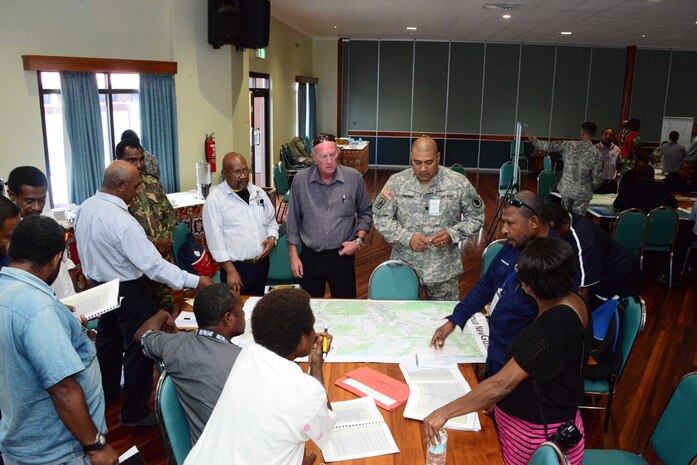In this file photo, U.S. and Papua New Guinea Defence Force soldiers, grouped with international and national organizations, discuss the best response course of action during the Oceania Pacific Resilience Disaster Response Exercise and Exchange, conducted May 11-15 in Lae, Papua New Guinea. The DREE is a five-day exercise, hosted by the Papua New Guinea Defence Force, that consisted of presentations and discussions from subject matter experts, a tabletop exercise and an after action review.