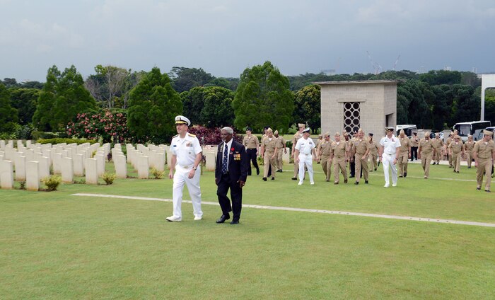 SINGAPORE (May 26, 2015) - Rear Adm. Charlie Williams, commander, Task Force (CTF) 73, and Kannaya Somu, Kranji War Cemetery Director, lead more than 100 Sailors assigned to CTF 73, and various tenant commands throughout Navy Region Singapore, through the cemetery.  The Sailors toured the Changi Prison Museum and the Kranji War Cemetery in commemoration of Memorial Day.   